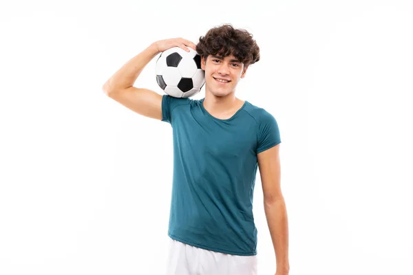 Молодой футболист за изолированной белой стеной — стоковое фото