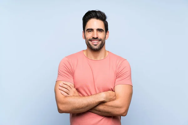 Handsome Young Man Pink Shirt Isolated Blue Background Keeping Arms — Stock Photo, Image