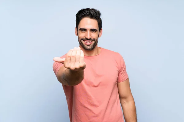 Handsome Young Man Pink Shirt Isolated Blue Background Inviting Come — Stockfoto