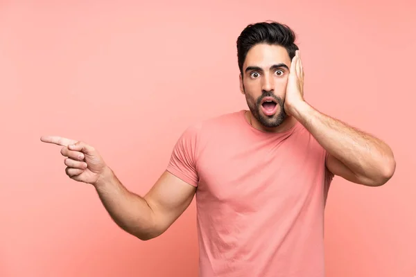 Bonito Jovem Sobre Isolado Fundo Rosa Surpreso Apontando Dedo Para — Fotografia de Stock