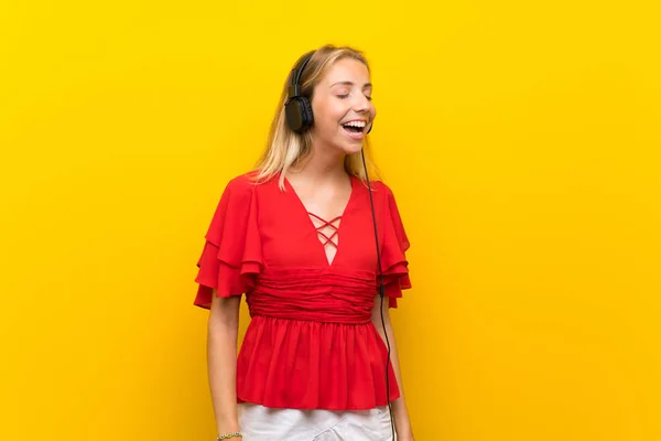 Blonde Young Woman Isolated Yellow Background Listening Music Headphones — Stock Photo, Image