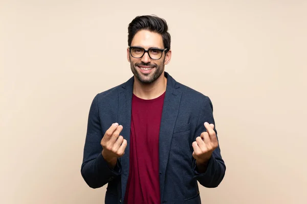 Guapo Joven Sobre Aislado Fondo Haciendo Gesto Dinero —  Fotos de Stock