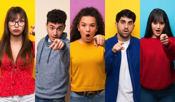 Set of people over colorful backgrounds surprised and pointing front