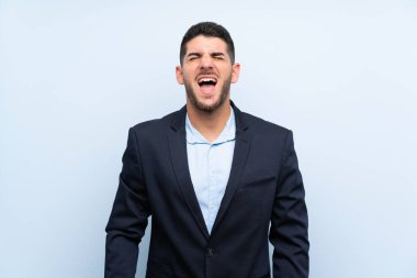 Ağzı tamamen açık ön bağırarak izole mavi arka plan üzerinde Yakışıklı adam