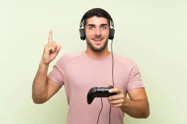 Young Handsome Man Playing Video Game Controller Isolated Green Wall — Stock Photo, Image