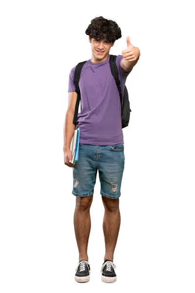 孤立した白い背景の上に何か良いことが起こったので 親指を上げた若い学生の男のフルレングスショット — ストック写真