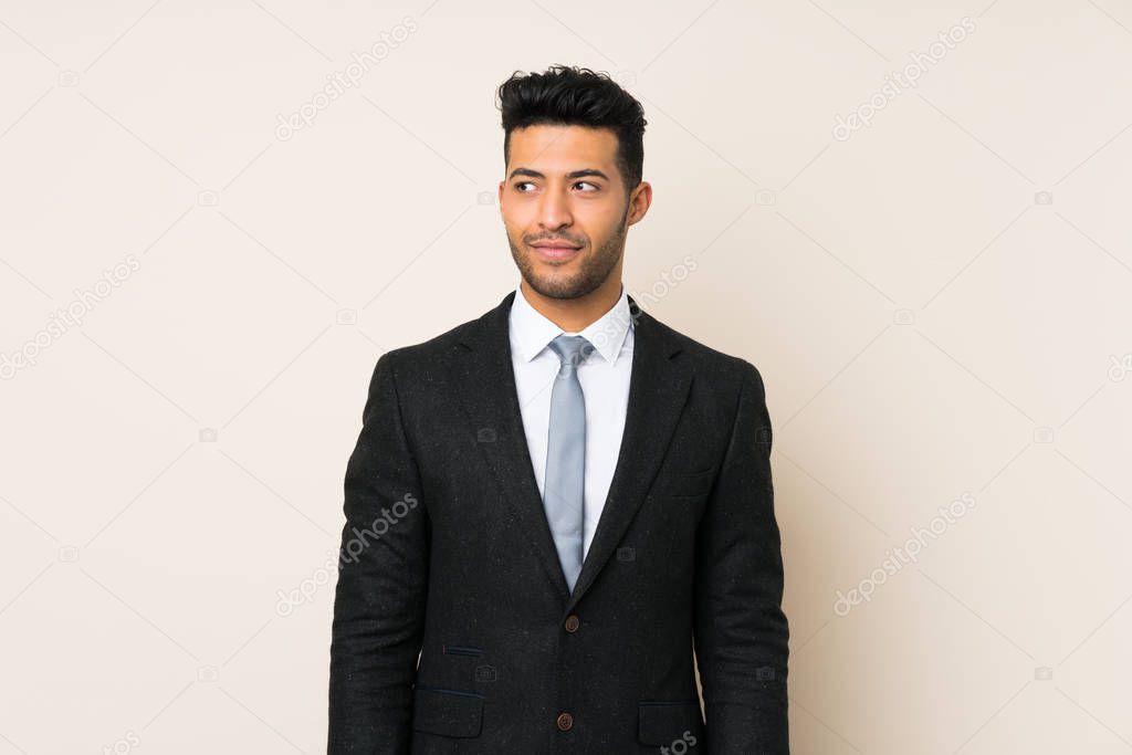 Young handsome businessman man over isolated background standing and looking to the side