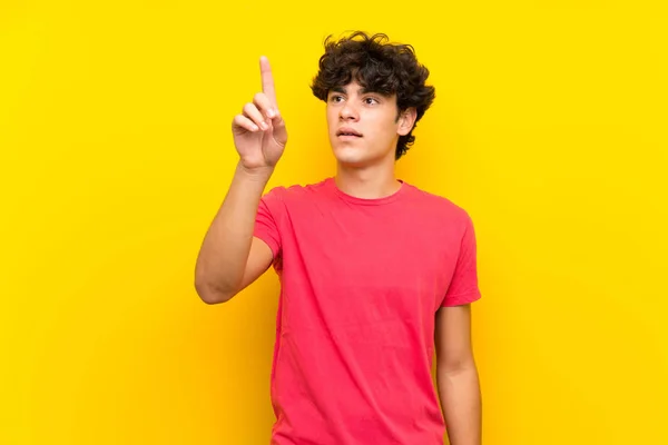 Young Man Isolated Yellow Wall Touching Transparent Screen — Stock Photo, Image