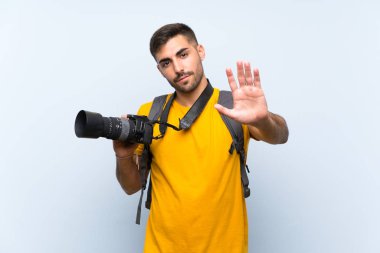 Young photographer man making stop gesture with her hand