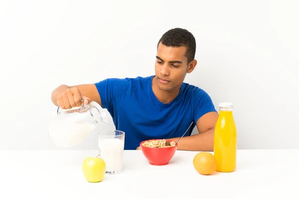 Young man having breakfast in a table — Stock Photo, Image
