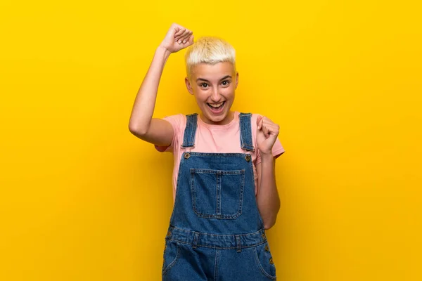 Teenager Girl Overalls Yellow Background Celebrating Victory — Stock Photo, Image