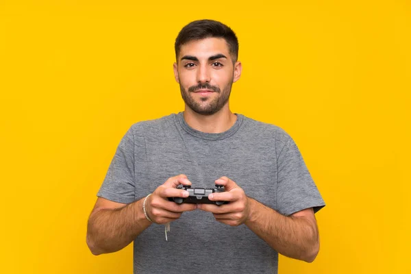 Young Handsome Man Playing Video Game Controller Isolated Yellow Background — Stock Photo, Image