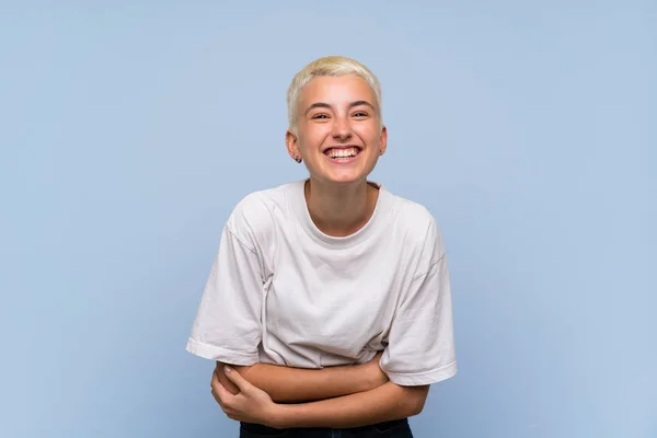 Stock image Teenager girl with white short hair over blue wall smiling a lot