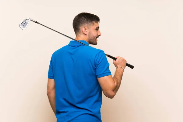 Jonge knappe golfer man over geïsoleerde achtergrond — Stockfoto
