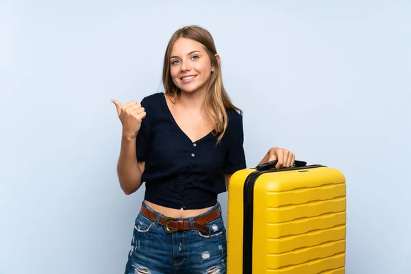 旅行者ブロンドの女性とスーツケースを指す側に製品を提示する — ストック写真