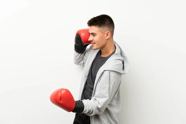 Sport man over isolated white wall with boxing gloves — Stock Photo, Image