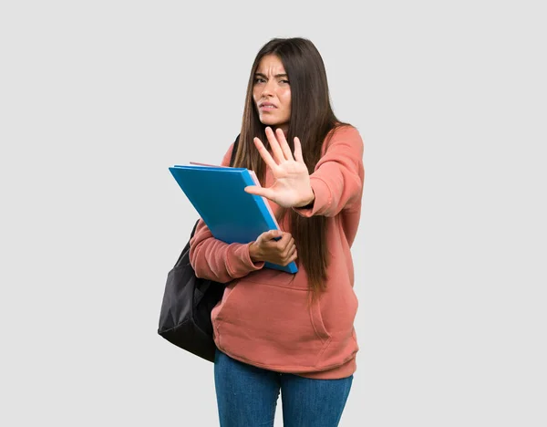 Young Student Woman Holding Notebooks Nervous Stretching Hands Front Isolated — Stock Photo, Image