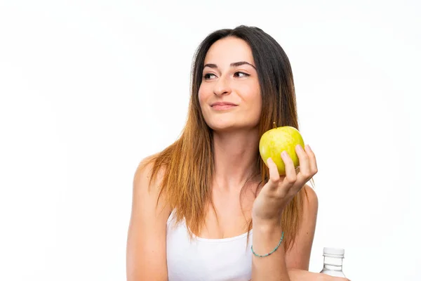 Ung kvinna med ett äpple över isolerad vit bakgrund — Stockfoto