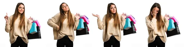 Sada mladé dívky s nákupními taškami přes izolované bílé pozadí — Stock fotografie