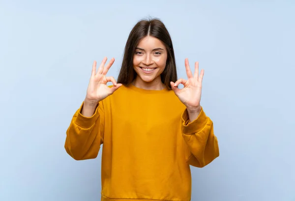 Kafkasyalı Genç Bir Kadın Izole Edilmiş Mavi Duvarda Parmaklarıyla Tamam — Stok fotoğraf