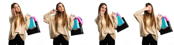 Set of young girl with shopping bags over isolated white background — ストック写真