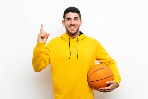 Schöner Junger Basketballspieler Mann Über Isolierte Weiße Wand Zeigt Auf — Stockfoto