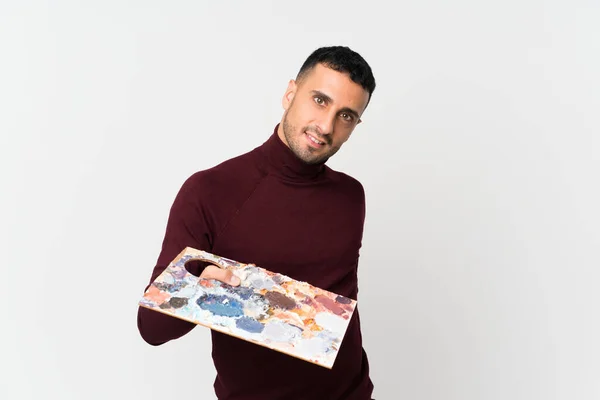 Joven Sobre Fondo Blanco Aislado Sosteniendo Una Paleta — Foto de Stock