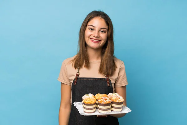 Jeune Fille Brune Sur Fond Bleu Isolé Tenant Mini Gâteaux — Photo