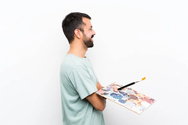 Genç Bir Sanatçı Arka Planda Yalıtılmış Bir Palet Tutuyor — Stok fotoğraf