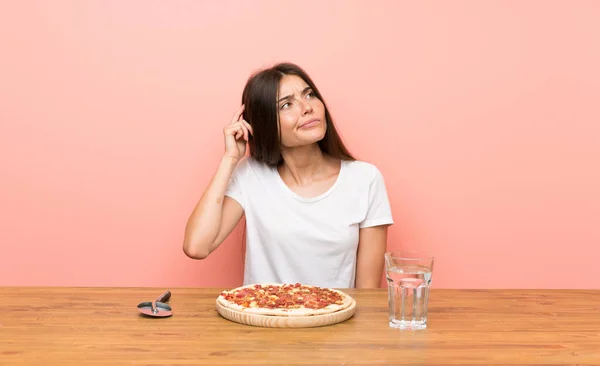 Junge Frau Mit Einer Pizza Zweifel Und Verwirrtem Gesichtsausdruck — Stockfoto