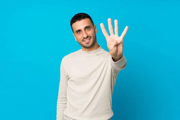 Joven Sobre Fondo Azul Aislado Feliz Contando Cuatro Con Los — Foto de Stock