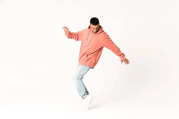 Man dancing street dance style over isolated white background