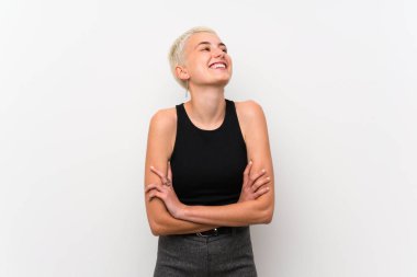 Teenager girl with short hair over white wall happy and smiling