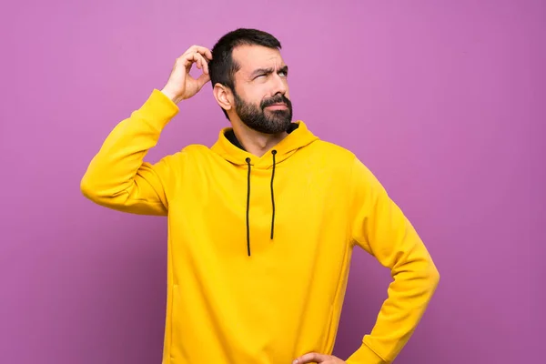 Handsome Man Yellow Sweatshirt Having Doubts While Scratching Head — 图库照片
