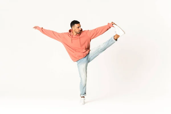 Man dancing street dance style over isolated white background