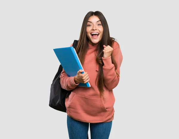 Young Student Woman Holding Notebooks Celebrating Victory Winner Position Isolated — Stock Photo, Image