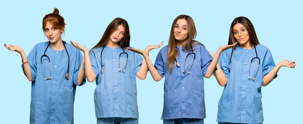 Group Nurses Having Doubts While Raising Hands Shoulders — Stock Photo, Image