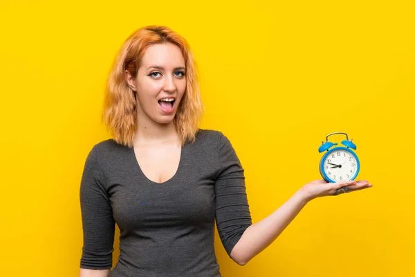 Young Woman Isolated Yellow Background Holding Vintage Alarm Clock — Stock Photo, Image