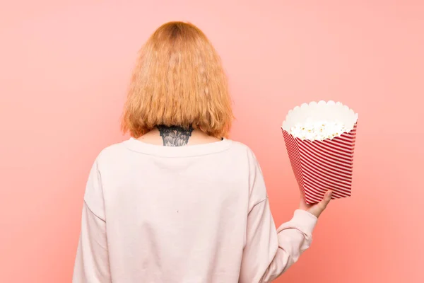 Młoda Kobieta Trzyma Dużą Miskę Popcornów Odizolowanym Różowym Tle Tylnej — Zdjęcie stockowe