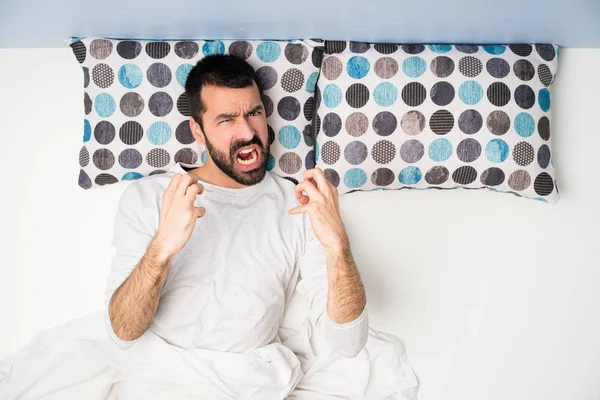 Man in bed in top view frustrated by a bad situation