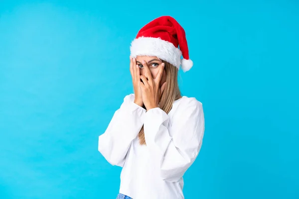 Menina Com Chapéu Natal Sobre Fundo Isolado Cobrindo Olhos Olhando — Fotografia de Stock