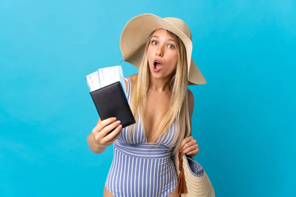Jonge Blonde Vrouw Met Een Paspoort Geïsoleerd Blauwe Achtergrond — Stockfoto