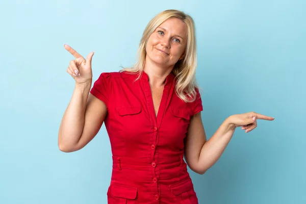 Frau Mittleren Alters Isoliert Auf Blauem Hintergrund Zeigt Mit Dem — Stockfoto