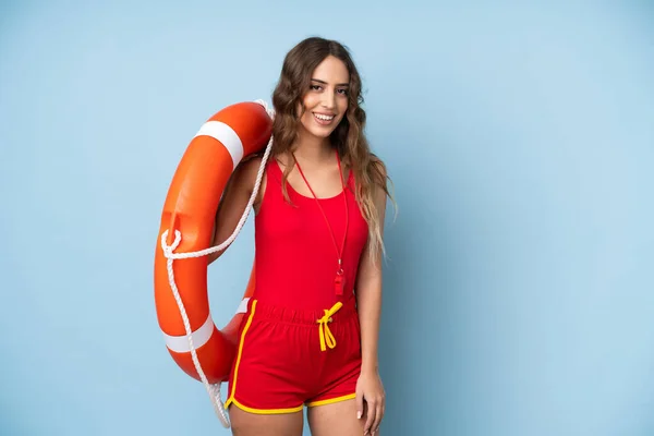 Young woman over isolated background with lifeguard equipment and smiling a lot