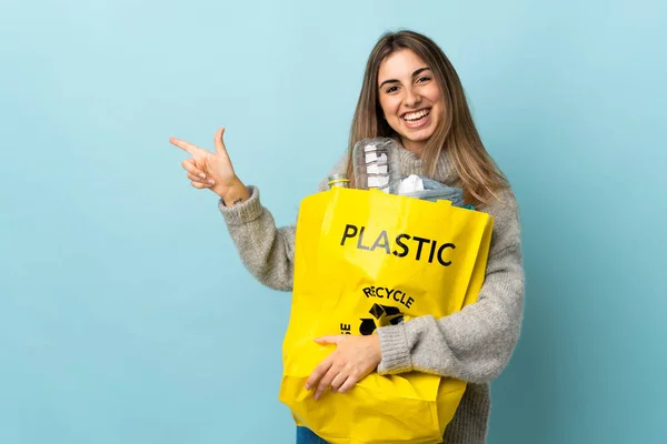 Holding Bag Full Plastic Bottles Recycle Isolated Blue Pointing Finger — Stock Photo, Image