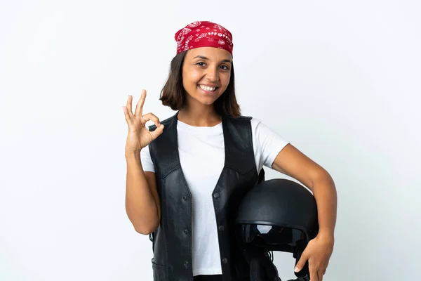 Young woman holding a motorcycle helmet isolated on white showing ok sign with fingers