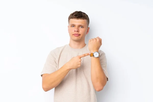 Молодий Красивий Чоловік Над Ізольованим Білим Тлом Показує Ручний Годинник — стокове фото