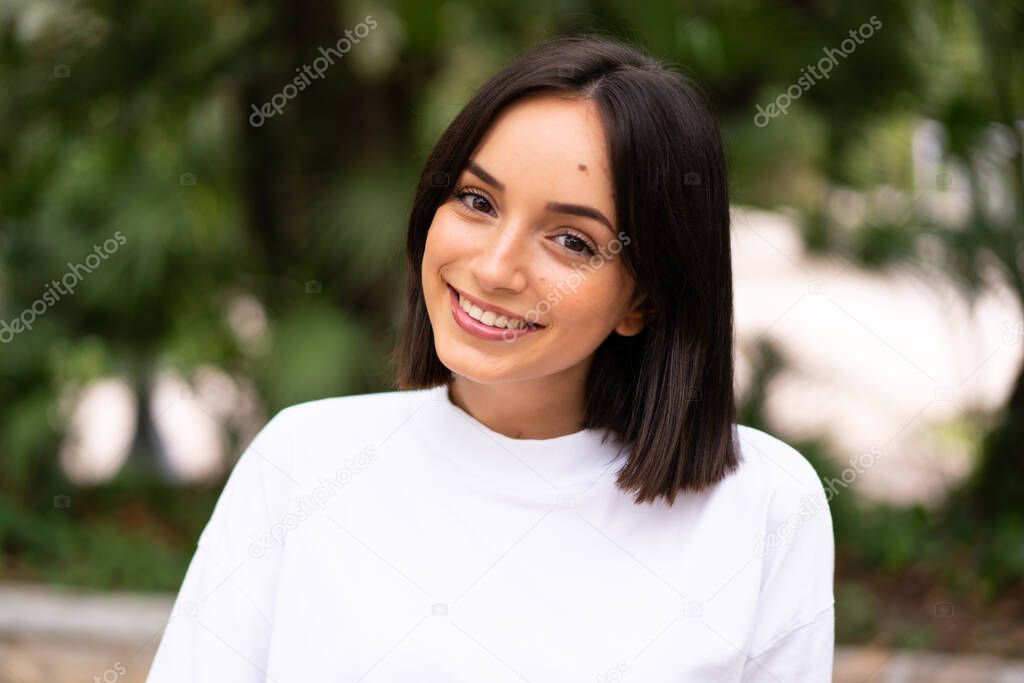 Young happy caucasian woman at outdoors