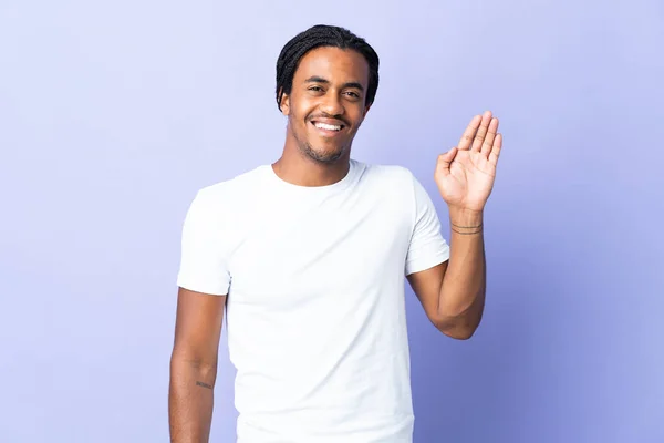 Young African American Man Braids Man Isolated Purple Background Saluting — Stock Photo, Image