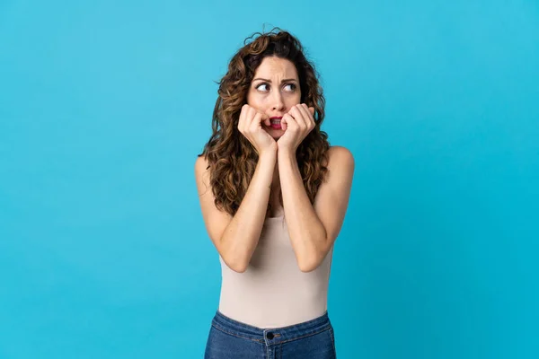 Young Caucasian Woman Isolated Blue Background Nervous Scared Putting Hands — Stock Photo, Image